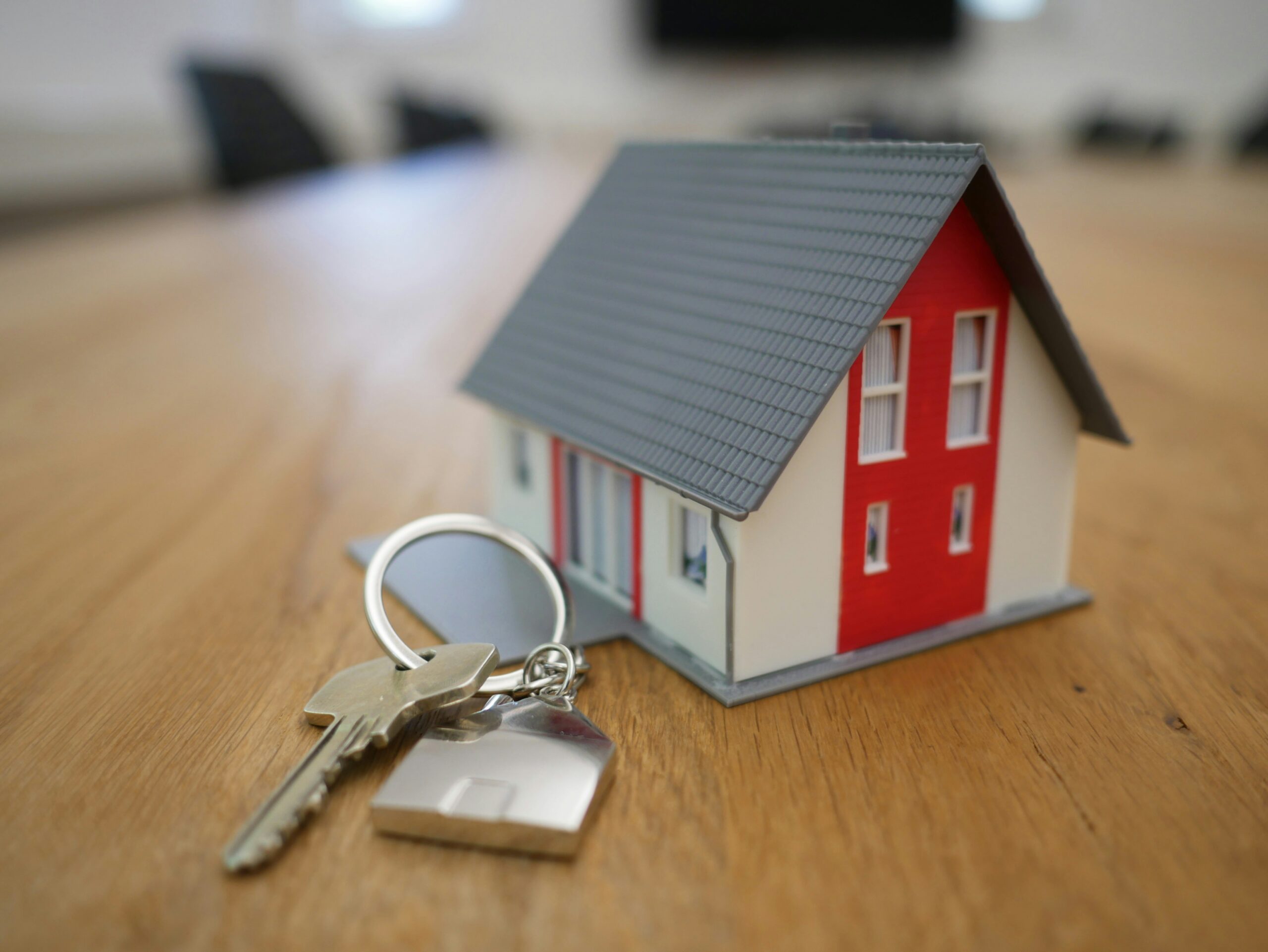 Model of a home with a house key.
